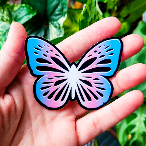 Monarch butterfly with a trans flag gradiant, representing the metamorphosis of transitioning.
